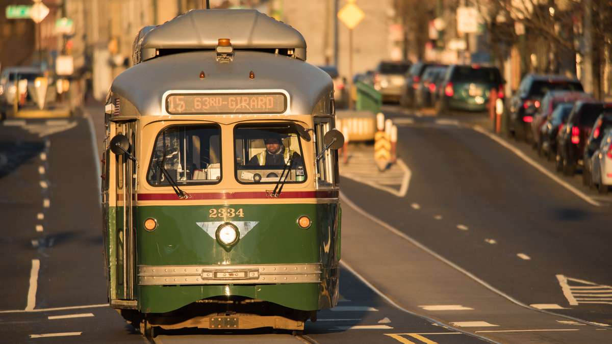 The Girard Avenue trolley gleams green and yellow in the light of the newly risen sun.