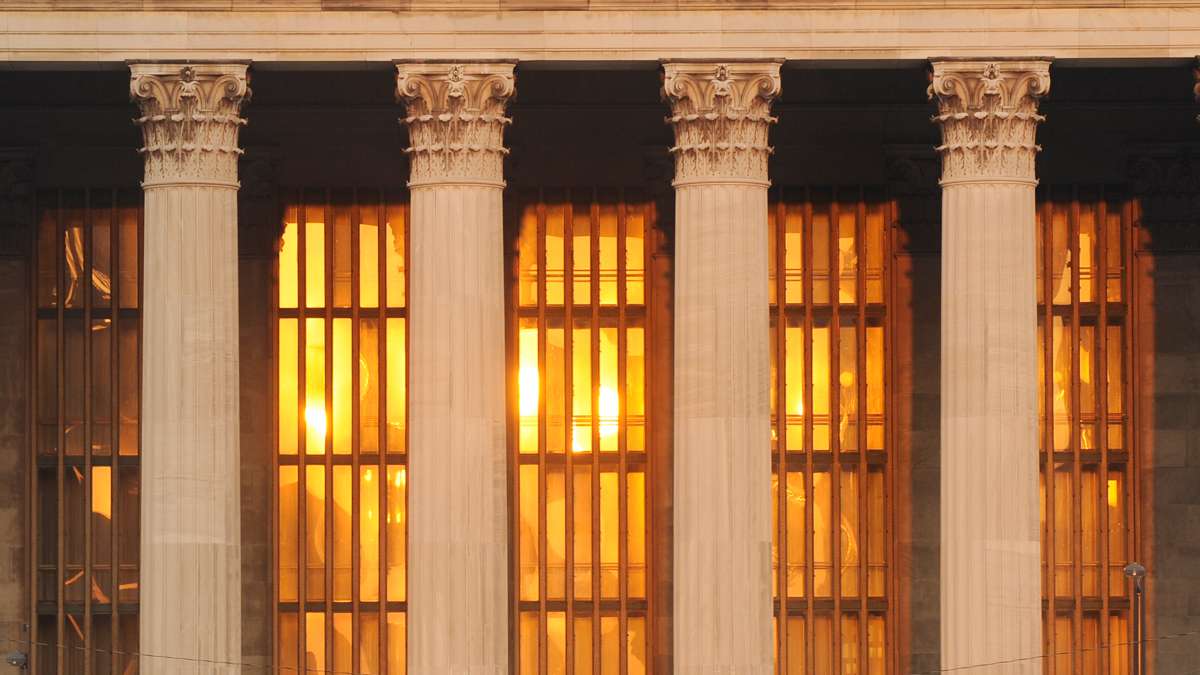 The rising sun is reflected in the windows behind the Corinthian columns of the Philadelphia Museum of Art.