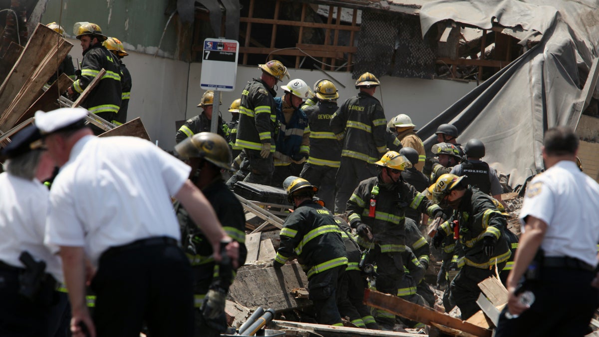  Rescue personnel search the scene of the building collapse in downtown Philadelphia. (AP Photo/Jacqueline Larma) 