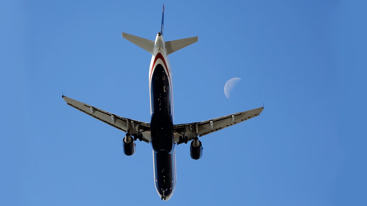  An airplane passes the moon as it makes its approach to Philadelphia International Airport, Wednesday, Nov. 4, 2015, in Philadelphia. (Matt Rourke/AP Photo) 