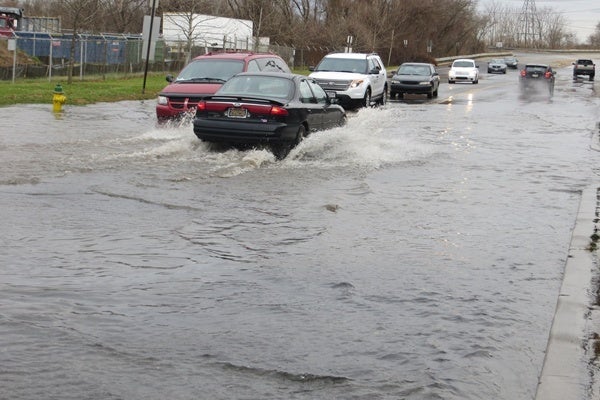 <p><p>Most cars tried to squeeze as close as possible to the center of the road where the water was shallowest. (Mark Eichmann/WHYY)</p></p>
