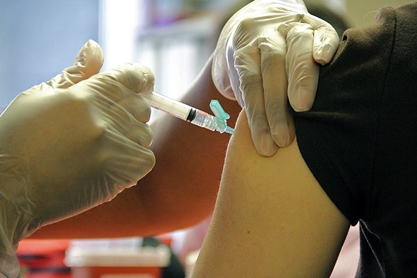 <p>Thomas Jefferson nurse Clarissa Knight injects Diana Allinger with flu vaccine during a free clinic for restaurant workers at Thomas Jefferson Hospital Center for Urban Health. (Emma Lee/for NewsWorks)</p>
