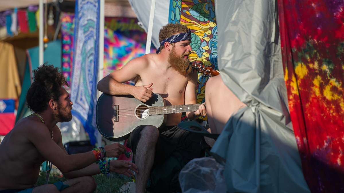 Matt Sharah (center) plays guitar with friends in the campgrounds.