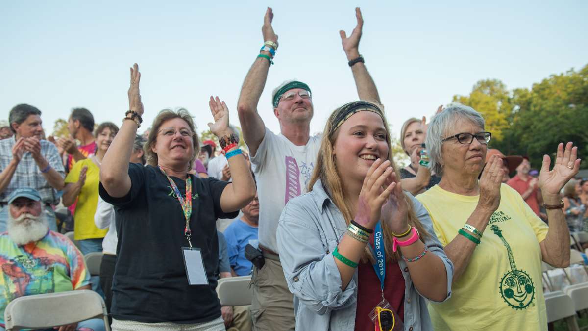 Festival-goers applaud the Irish-Latin fusion band Baile An Salsa at the conclusion of their performance. (Jonathan Wilson for NewsWorks)