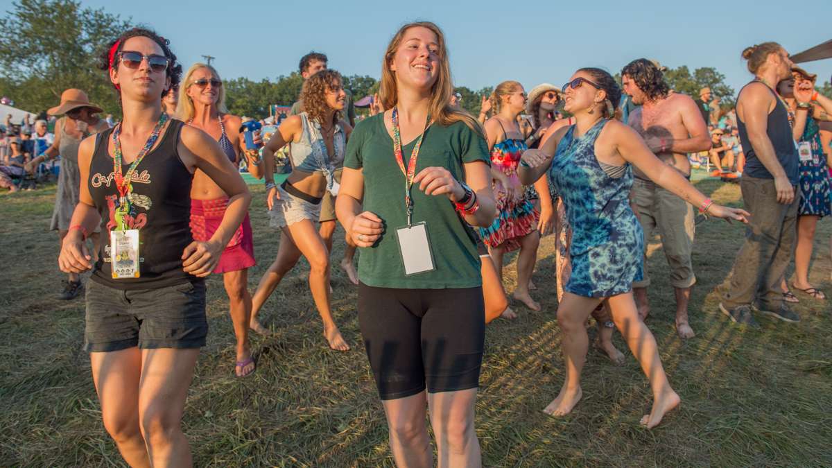 Festival-goers dance to the music of the Irish-Latin fusion band Baile An Salsa. (Jonathan Wilson for NewsWorks)