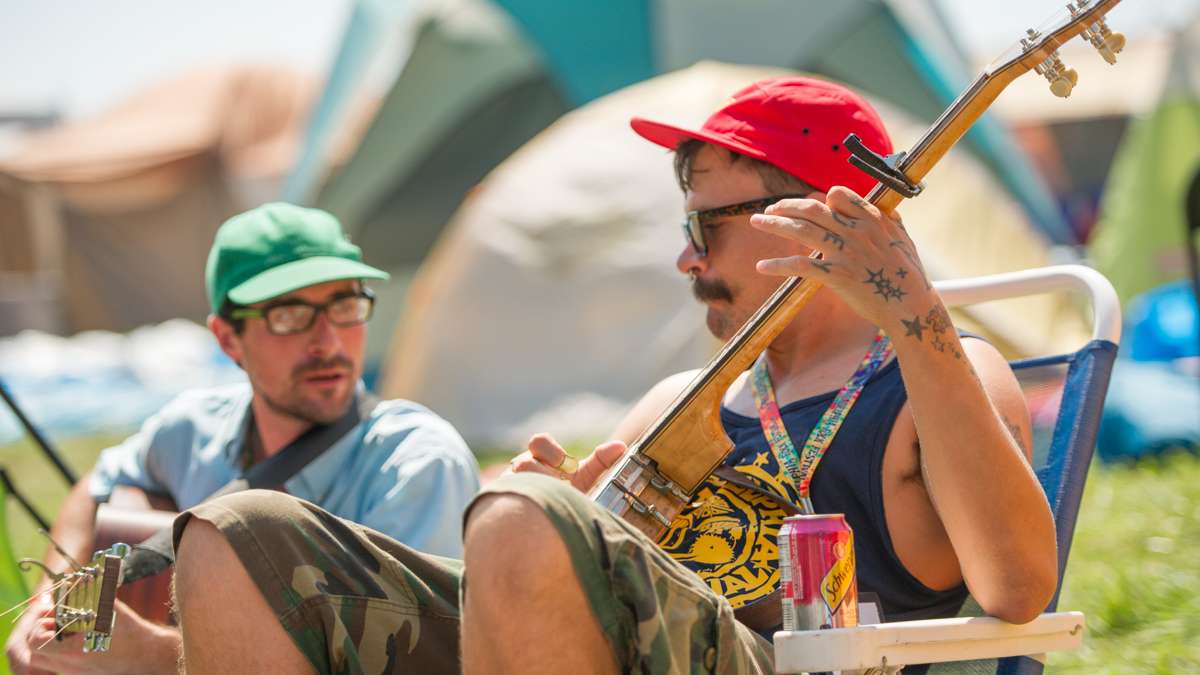 In the festival campground, Danny Mulligan (left) and Huey McBanjo play Blue Grass music. The two are members of the South Philadelphia group The White Cheddar Boys. (Jonathan Wilson for NewsWorks)