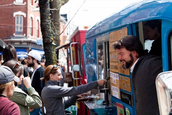 Parker Whitmore, owner of Zsa's Ice Cream, greets customers outside of his vintage truck, named Gatsby, Saturday. (Brad Larrison/For NewsWorks)