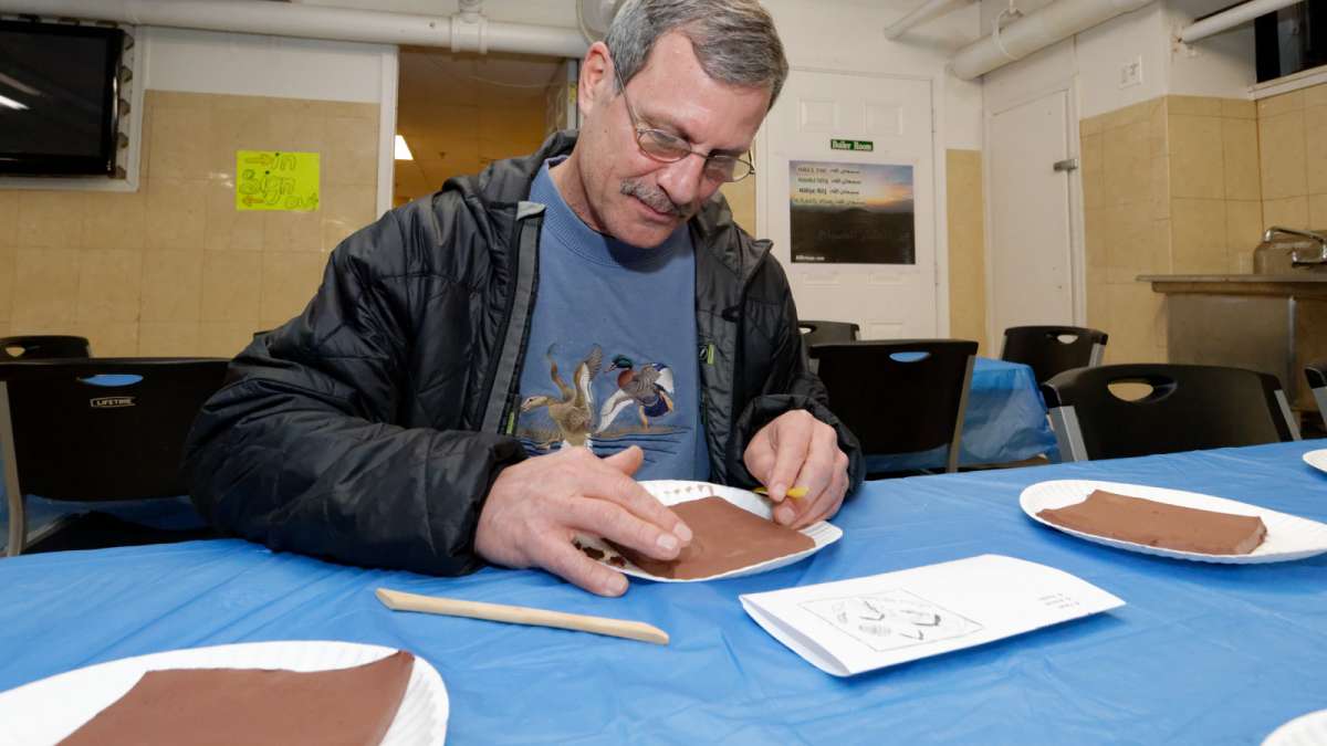 Steve Perkiss of Mount Airy works on a tile. (Bastiaan Slabbers/for NewsWorks)  