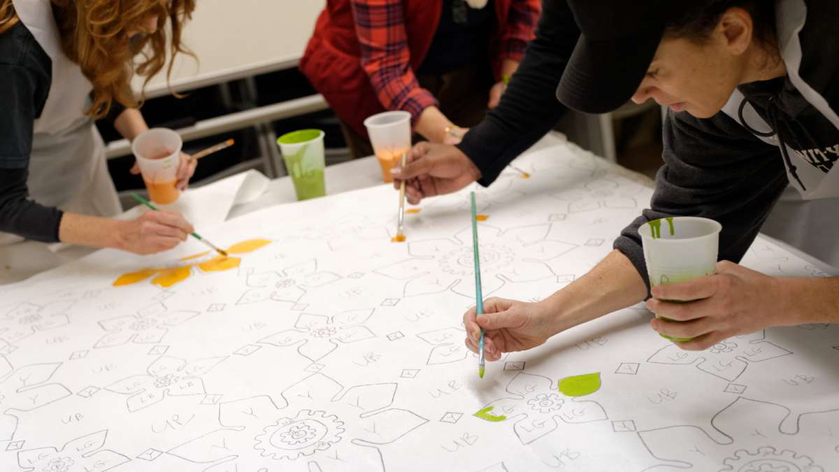 Rebecca Fabiano of North Philadelphia paints one of the canvasses. (Bastiaan Slabbers/for NewsWorks)  