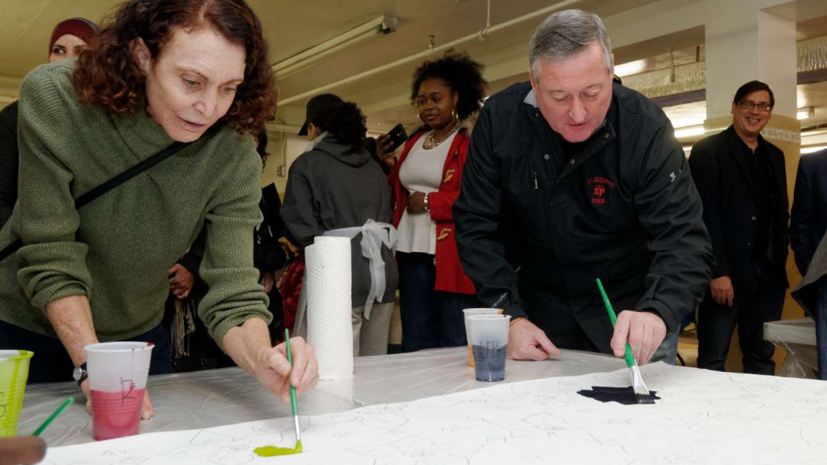 Mural Arts Program Executive Director Jane Golden and Mayor Jim Kenney work on one of the canvasses. (Bastiaan Slabbers/for NewsWorks)  