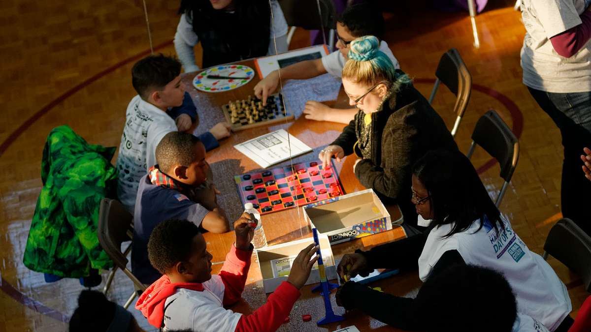 Participants in the Martin Luther King Day of Service event at Girard College play board games. (Bastiaan Slabbers/for NewsWorks)