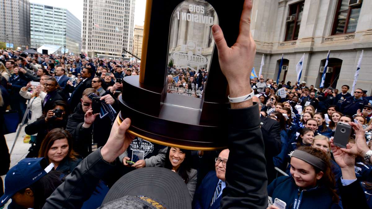 Ryan Arcidiacono presents the NCAA Championship trophy to a crowd at Dilworth Plaza on Friday.