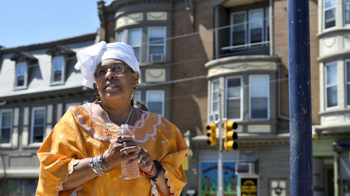 To honor ancestors, elder Iraina Salaa of Germantown pours libation at the base of the marker that commemorates the first protests against slavery.