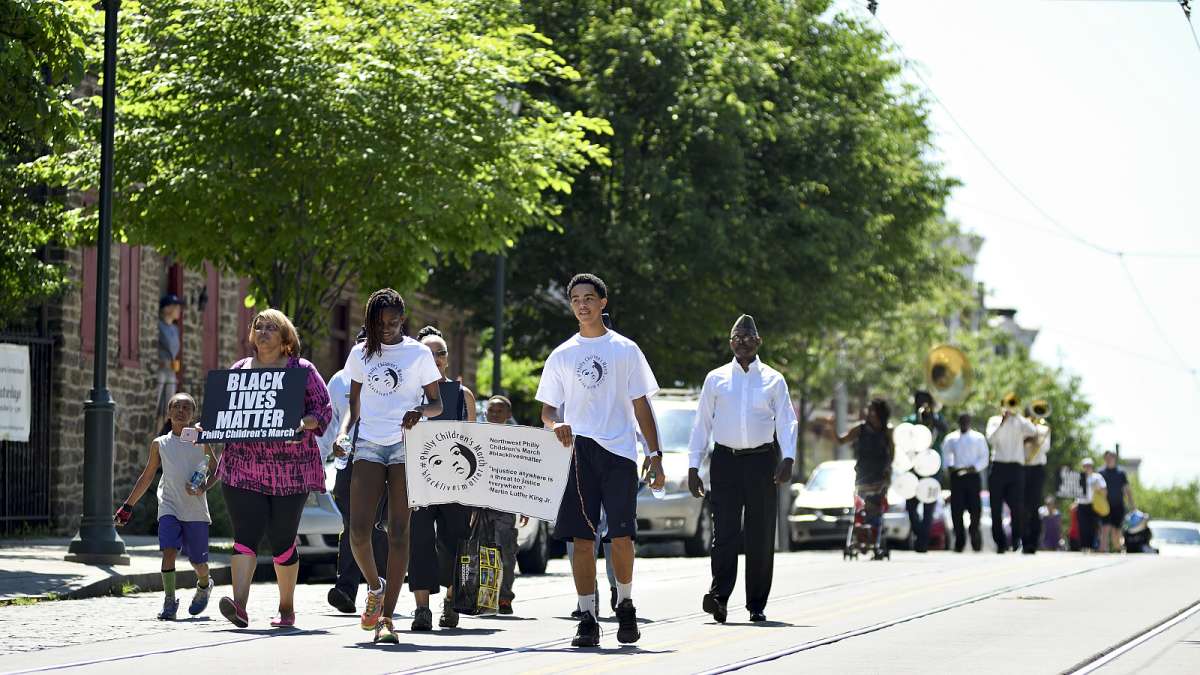 The Philly Children’s March leads the Freedom Parade past Grumblethorpe on Germantown Avenue as they walk from the historic marker to the Juneteenth Festival near Johnson House Historic Site.