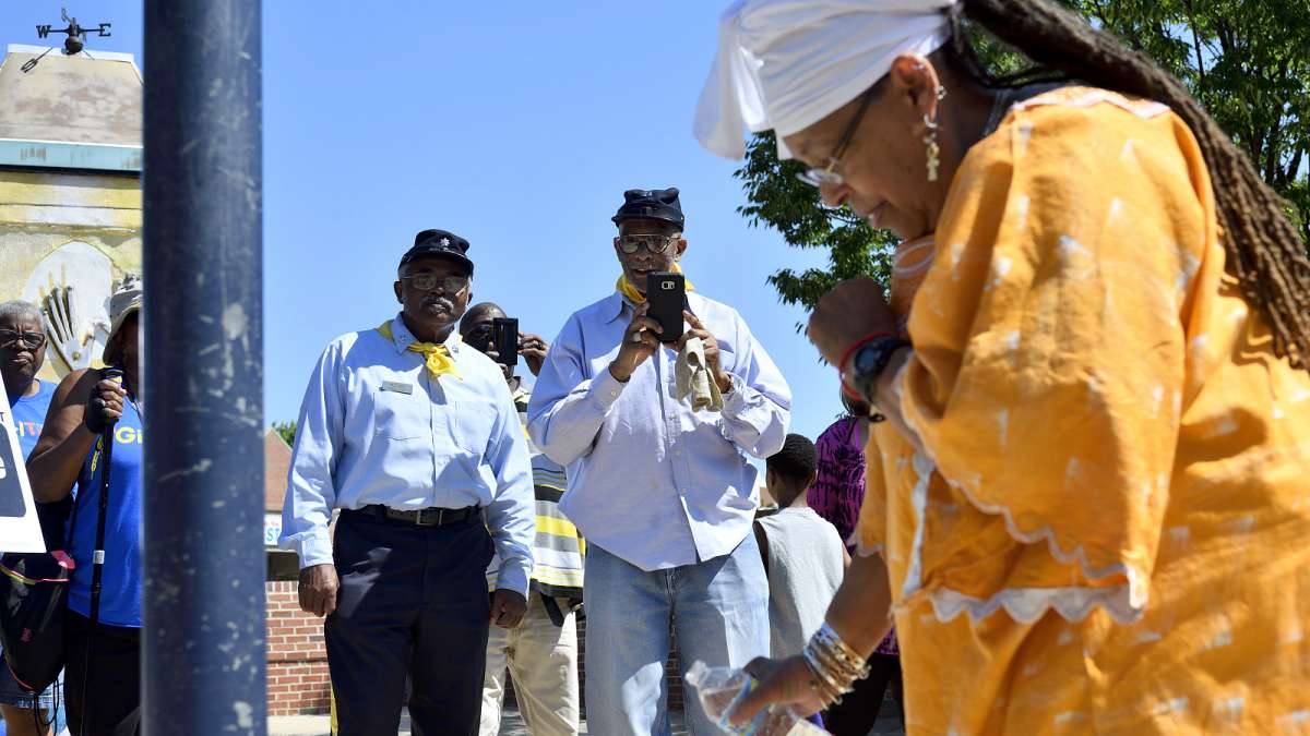 ''Cornel'' John McCall and ''Captain'' Hassan Ali Hameen, representing the ''Resurrected Order'' of Buffalo Soldiers Philadelphia Chapter, watch the pouring of libation at the historic marker.