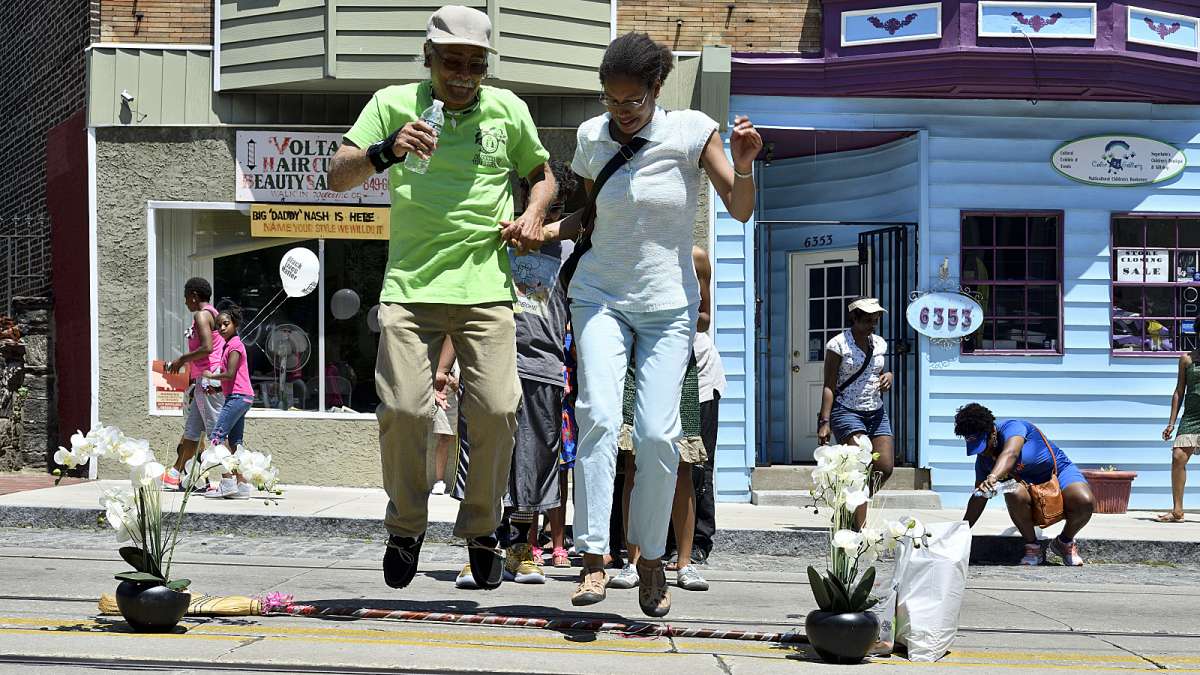 Couples jump the broom during the Juneteenth Festival on Germantown Avenue. The jumping of brooms is African-American tradition that was part of wedding ceremonies of slaves in the South.