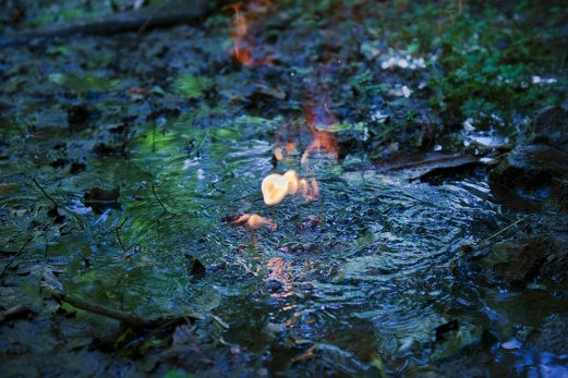 <p><p>Water on fire because of the natural gas bubbling up from a natural spring. The gas showed up in the spring after David Headley's property was fracked in Smithfield, Pa. He discovered the bubbles when horses he owned stopped drinking water from this location. (Scott Goldsmith/Marcellus Shale Documentary Project)</p></p>
