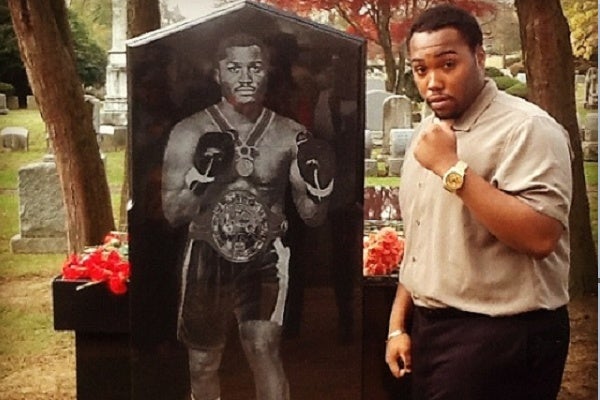 <p><p>Frazier's youngest son Derek poses next to a likeness of the boxing legend who died of liver cancer in Nov. 2011. (Courtesy of Derek Frazier)</p></p>
