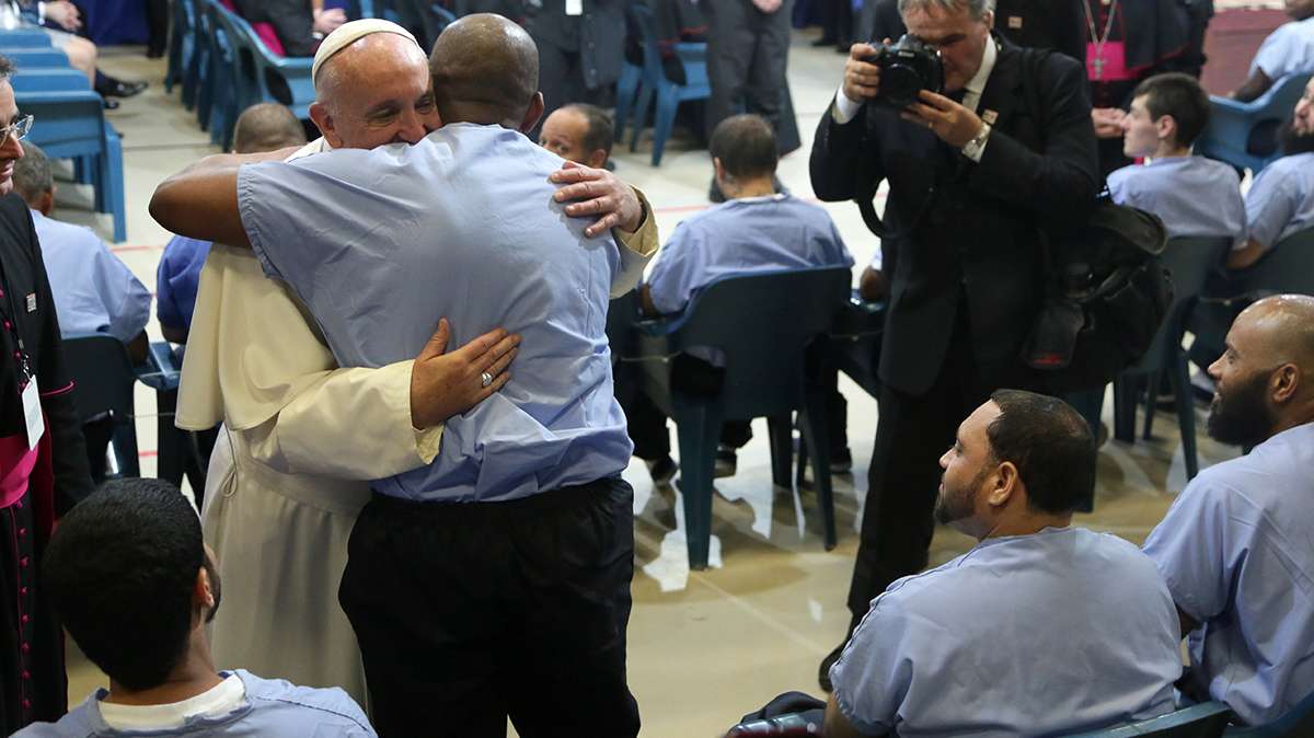 Two inmates jumped up to hug the pontiff. (Kevin Cook/for NewsWorks)