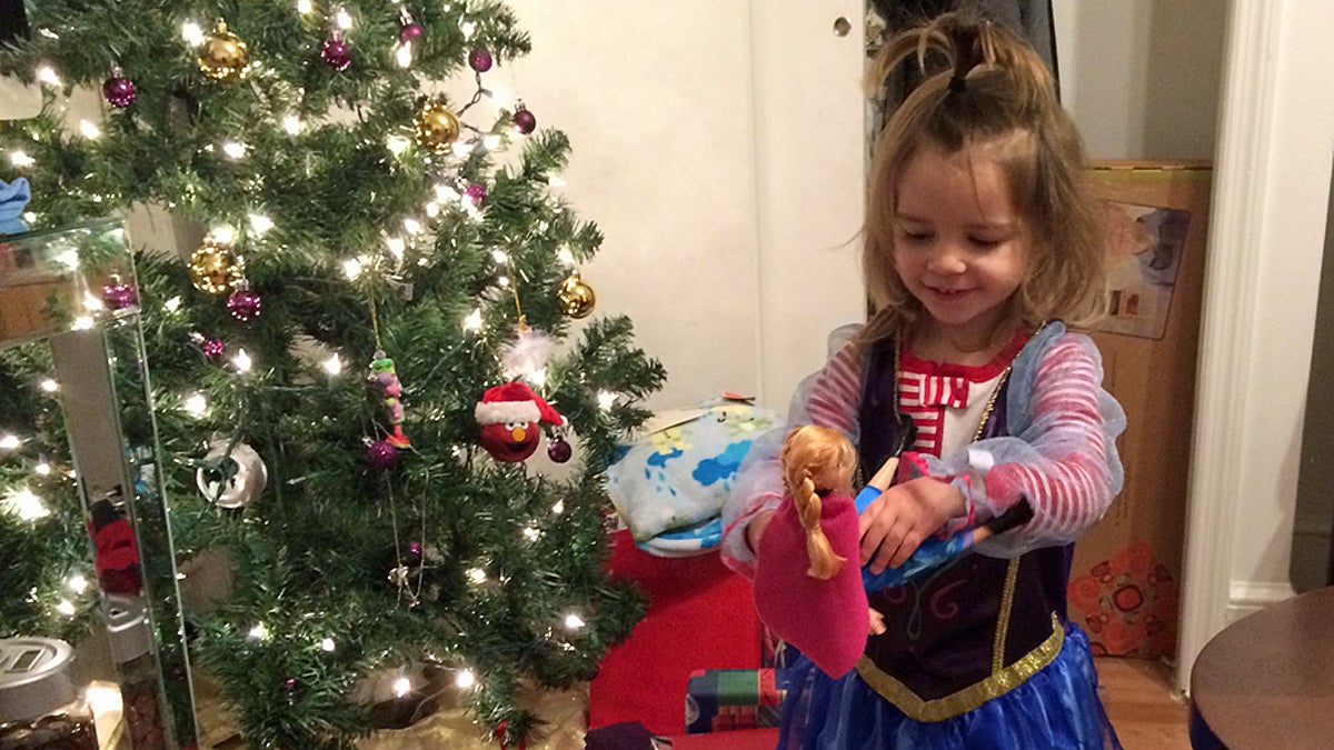  Ella Janos,2, wearing a costume and holding a doll from the Disney movie 'Frozen' (Image courtesy of Joseph Janos) 