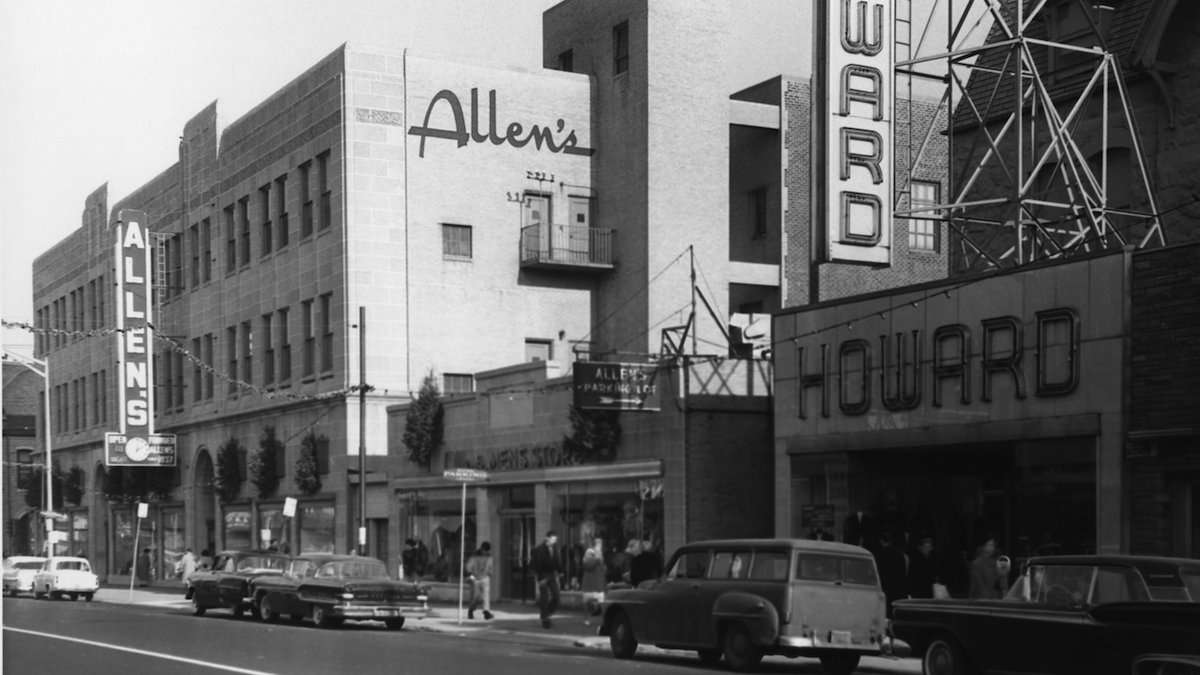 Black and white photograph of general view of Allen's Department Store, taken from the north side of Chelten Avenue facing east-northeast towards Germantown Avenue and Armat Street. Note period cars along Chelten Avenue, with trolley tracks removed. n.d. , circa 1960. (Courtesy of Germantown Historical Society, Philadelphia, PA)