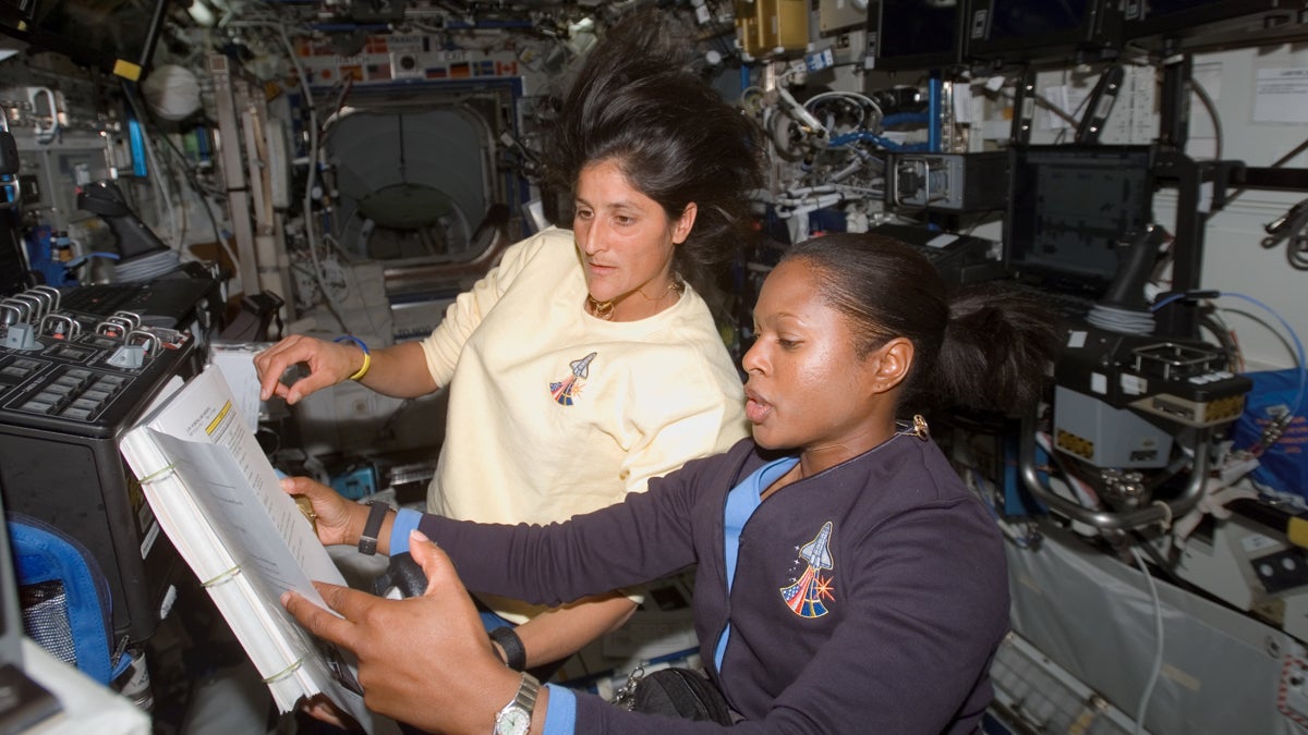 Astronauts Joan E. Higginbotham and Sunita L. Williams refer to a procedures checklist as they work together in the Destiny laboratory of the International Space Station. (<a href=
