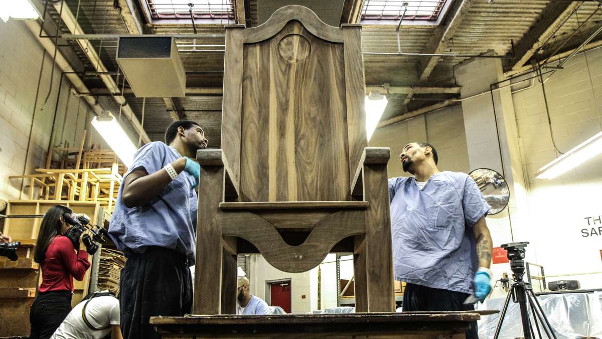 Inmates at Philadelphia Industrial Correctional Center sand a chair the Philadelphia prison will give to Pope Francis during his visit. (Kimberly Paynter/WHYY)