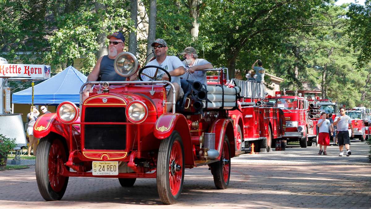 At the end of the muster, the fire engines parade past spectators as the exit the WheatonArts grounds. (Jana Shea for NewsWorks)