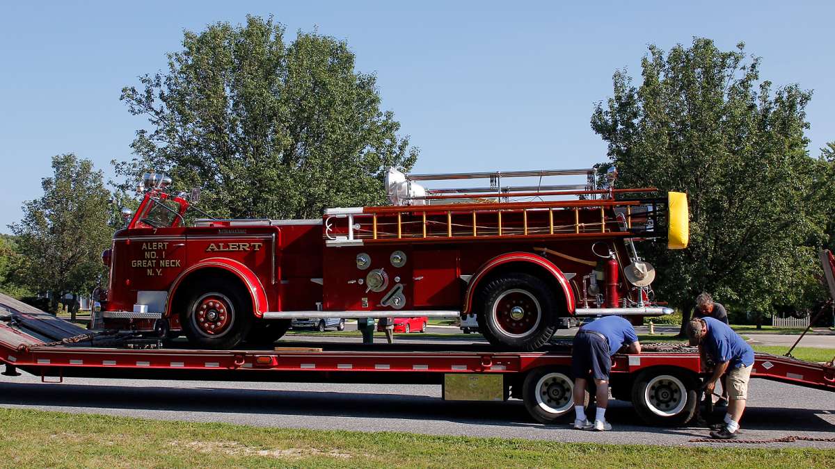Some of the historic fire engines are transported to the muster via flatbed trailer. (Jana Shea for NewsWorks)