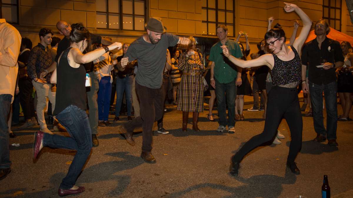 People dance to the music of the West Philadelphia Orchestra at Fairmount Park Conservancy's 5th annual Glow in the Park gathering.