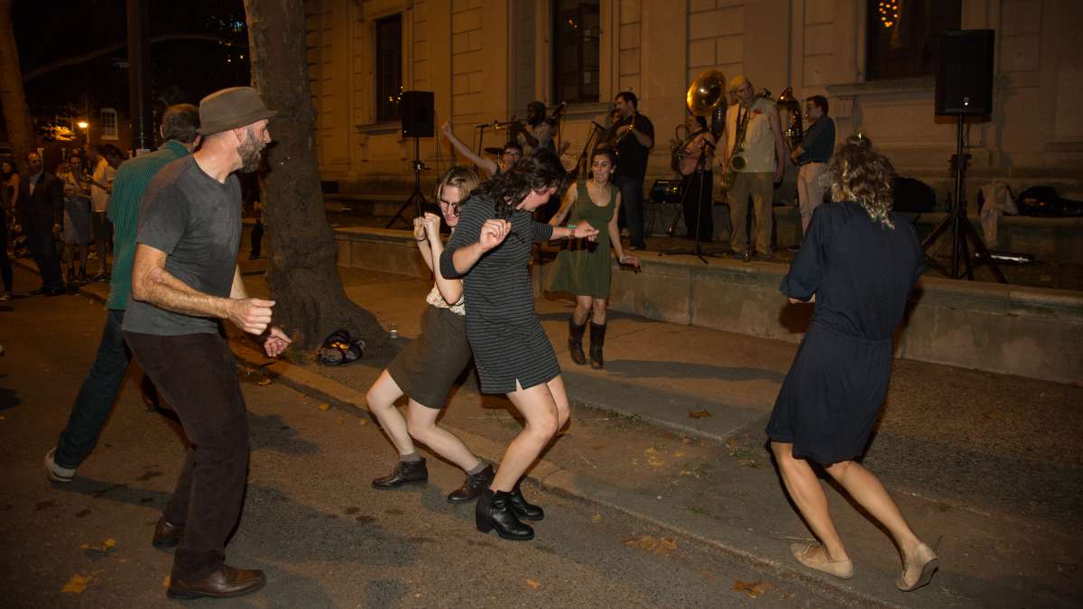 People dance to the music of the West Philadelphia Orchestra at Fairmount Park Conservancy's 5th annual Glow in the Park gathering.