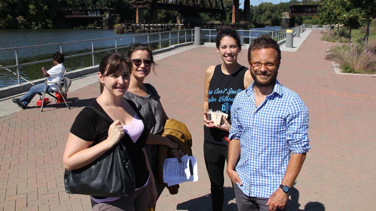 Festival planners (from left) Danielle Gray of Schuylkill River Development Corp., Katey Metzroth of Secondmuse, Molly Baum of Hacktory and Alex Gilliam of Public Workshop, gather at Grays Ferry Crescent Trail Park to finalize their plans for Discover the Crescent. (Emma Lee/for NewsWorks)