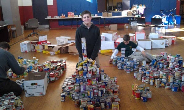 <p><p>Seventh grade student Ben Gongon poses with his tower of beans. (Yasmein James/for NewsWorks)</p></p>
