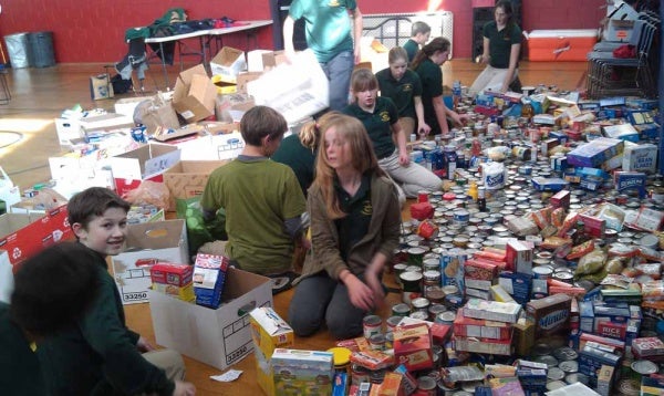 <p><p>After taking the non-perishable items out of the boxes, the students quickly began making piles for North Light Community Center's cupboard. (Yasmein James/for NewsWorks)</p></p>
