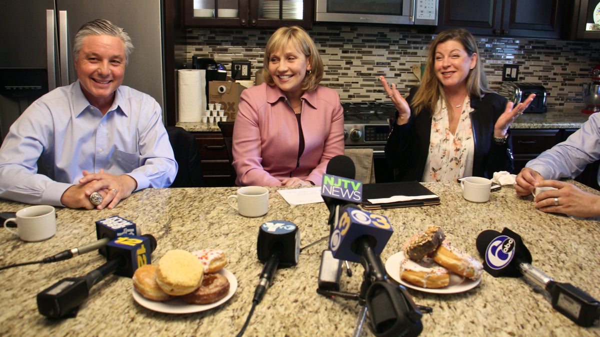  Republican nominee for New Jersey governor Kim Guadagno (center) promises lower property taxes during a press event in the suburban kitchen of Rennie and Phil Wessner. Seated to Guadagno's right is Evesham Mayor Randy Brown and on her left is homeowner Rennie Wessner. (Emma Lee/WHYY) 