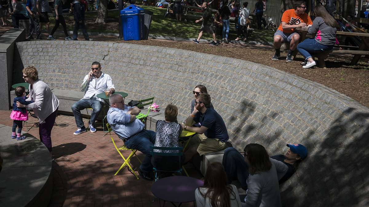 Visitors relax in the sun and shade during the opening weekend of the Spruce Street Harbor Park.