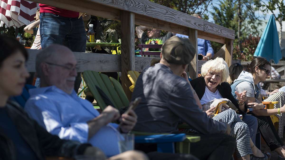 Eileen Augustine chats with friends during the opening weekend of the Spruce Street Harbor Park.