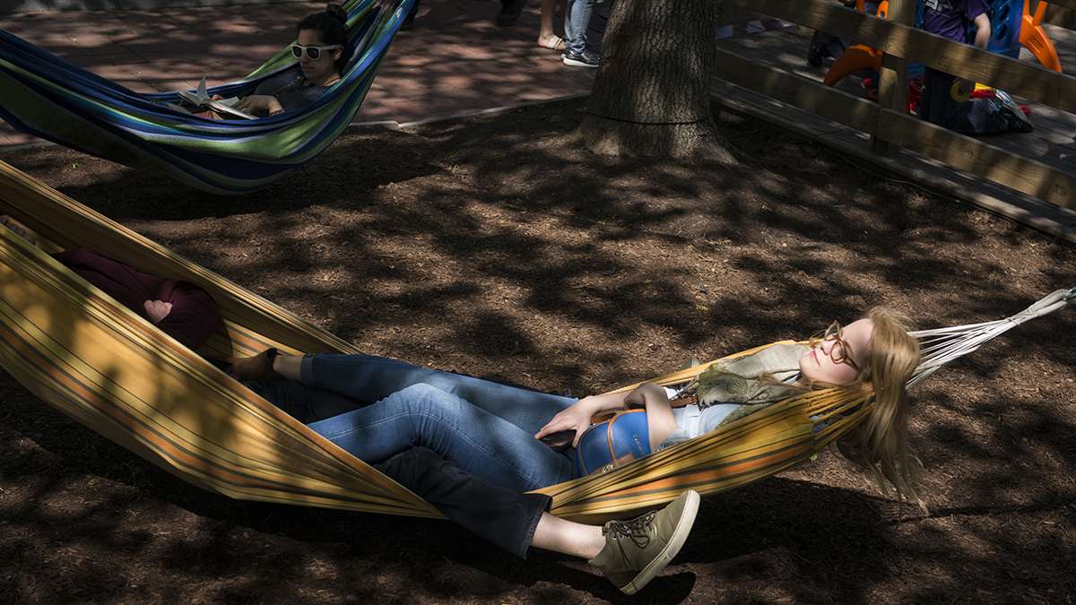 Elizabeth Riggio relaxes in one of the more than 50 hammocks at the Spruce Street Harbor Park.