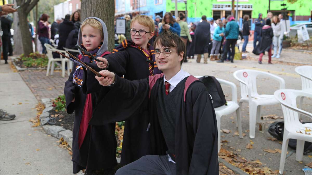 Harry Potter (Dan Lemoine) casting a spell with fans Desmond and Damien (Natavan Werbock/for NewsWorks)