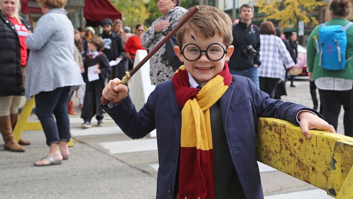 First grader David waving his magic wand at the Harry Potter Festival in Chestnut Hill, in 2015. (Natavan Werbock for WHYY)