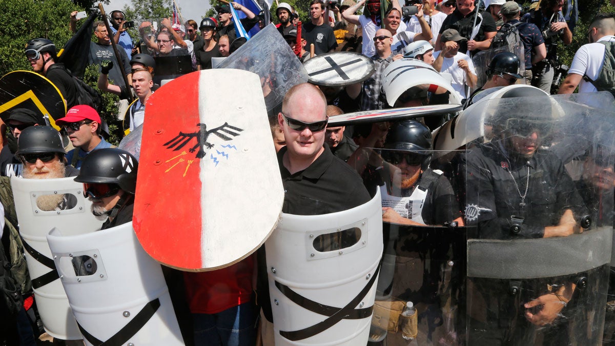 White nationalist demonstrators use shields as they guard the entrance to Lee Park in Charlottesville, Va., Saturday, Aug. 12, 2017. (AP Photo/Steve Helber)