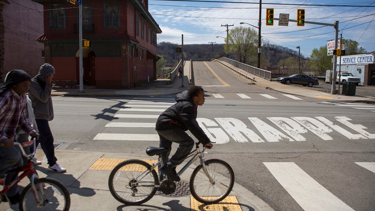  Kids ride their bikes in the Pittsburgh neighborhood of Hazelwood. (Jessica Kourkounis for Keystone Crossroads) 