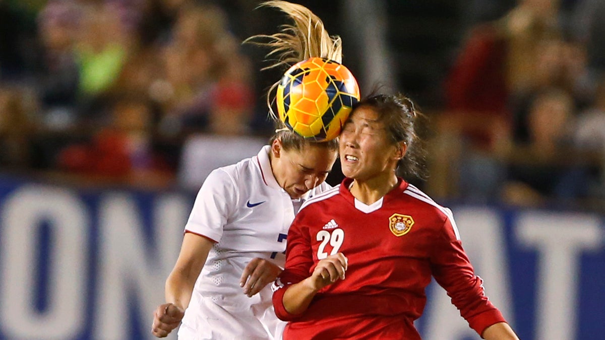  China forward Yang Li and U.S. midfielder Morgan Brian vie for a head ball. (Lenny Ignelzi/AP) 
