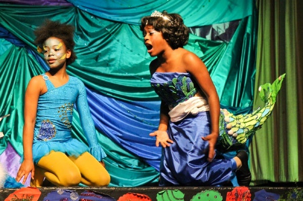 <p>6th grade student Mizan Ahmad as the character Flounder and 8th grade student Jhayda Washington as Ariel in Henry Elementary's production of The Little Mermaid. (Kimberly Paynter/for NewsWorks)</p>
