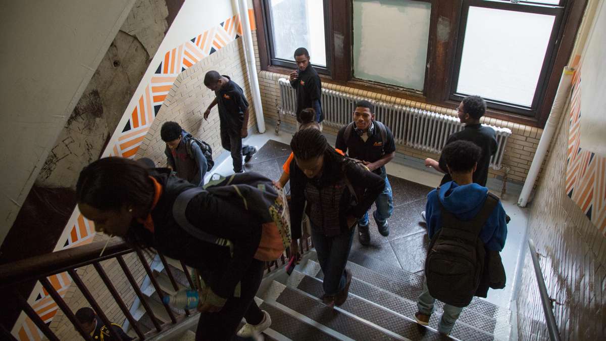 Students pass though a stairwell at Overbrook High School. The school has 5 floors, only 3 of which are in active use, not incuding the basement levels. (Emily Cohen for NewsWorks)