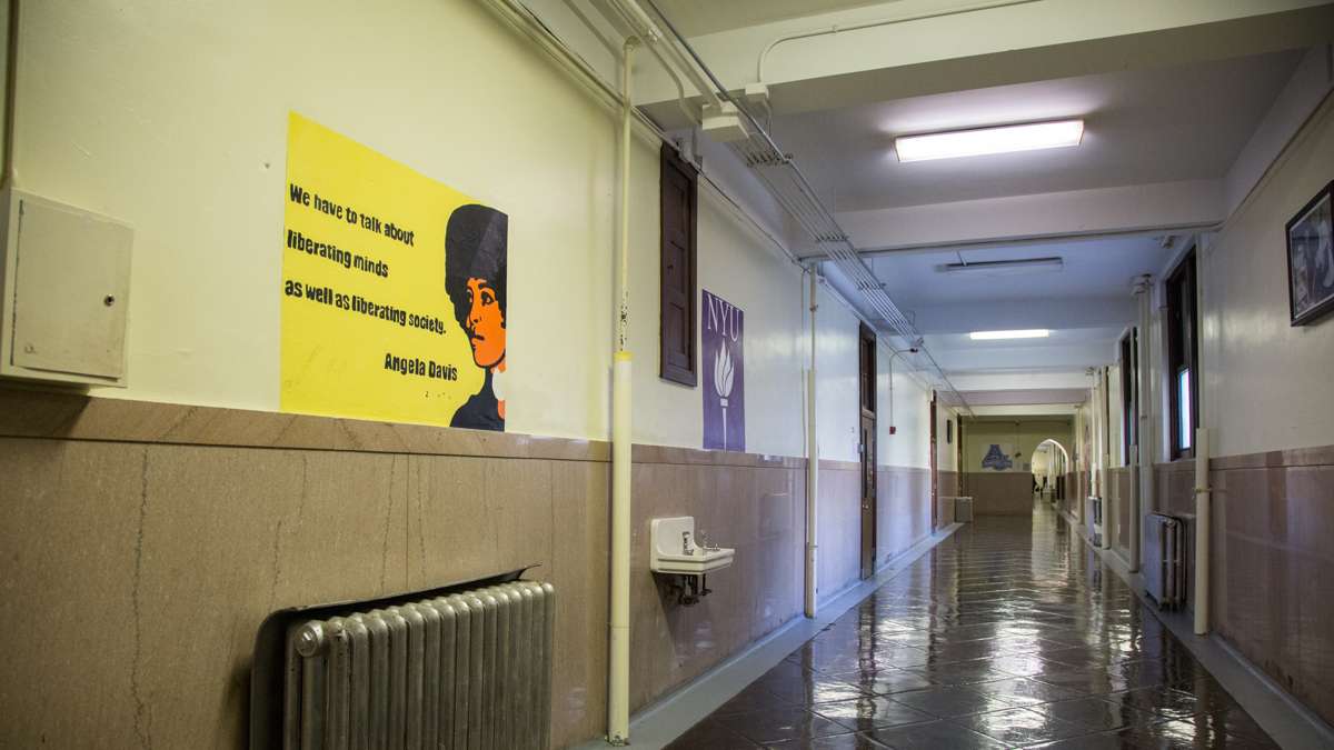 Artwork with inspirational quotes and insignias of colleges adorn the walls of Overbrook High School. (Emily Cohen for NewsWorks)