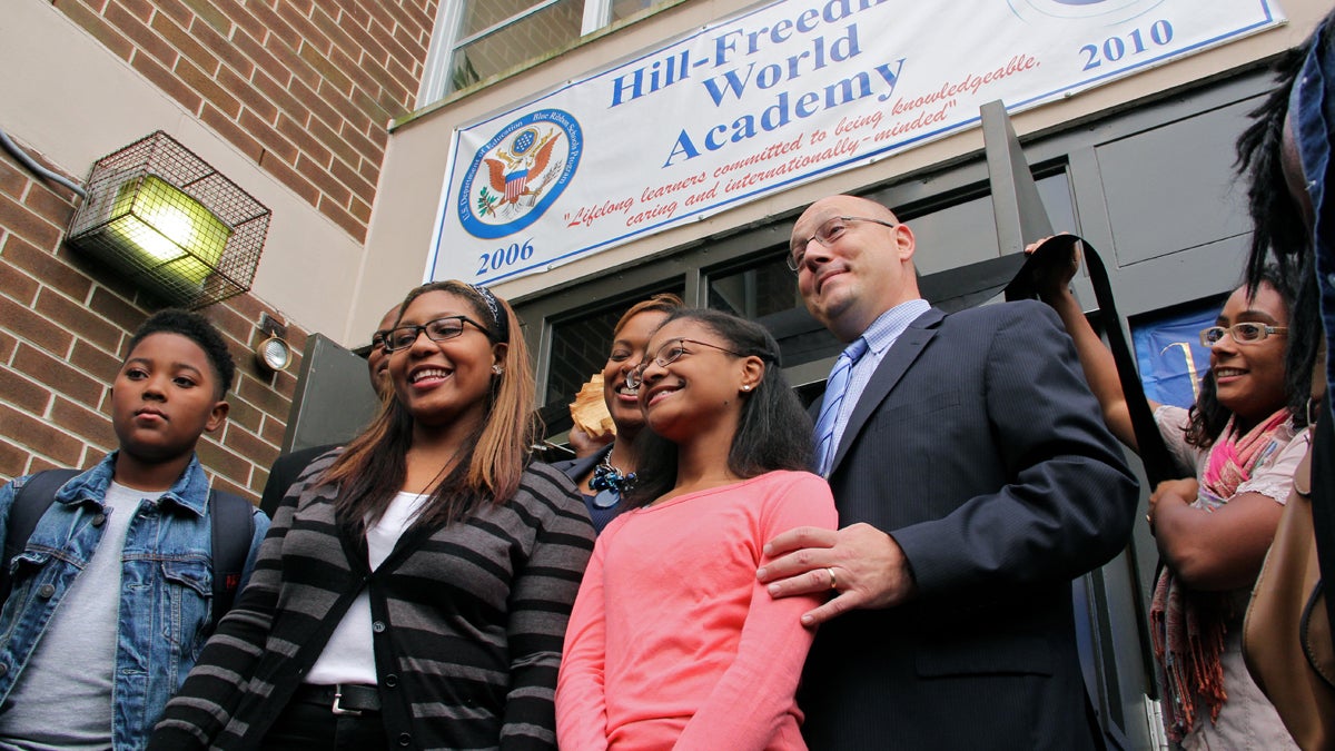  Hill-Freedman Principal Anthony Majewski poses with students (from left) Jason Temple, Serenity Stephens and Destinaé Mason before the ribbon is cut for the school's new 9th grade class. (Emma Lee/for NewsWorks) 