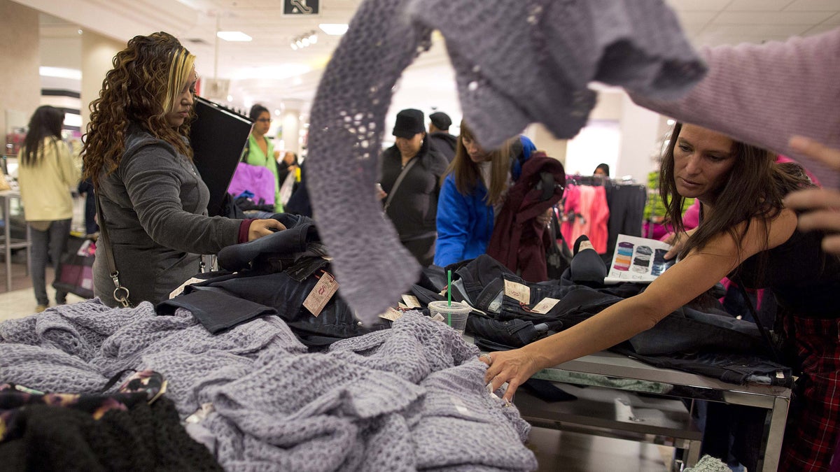  Shoppers rummage through a pile of sweaters on sale at a J.C. Penney store in Las Vegas. (AP Photo/Julie Jacobson, file) 