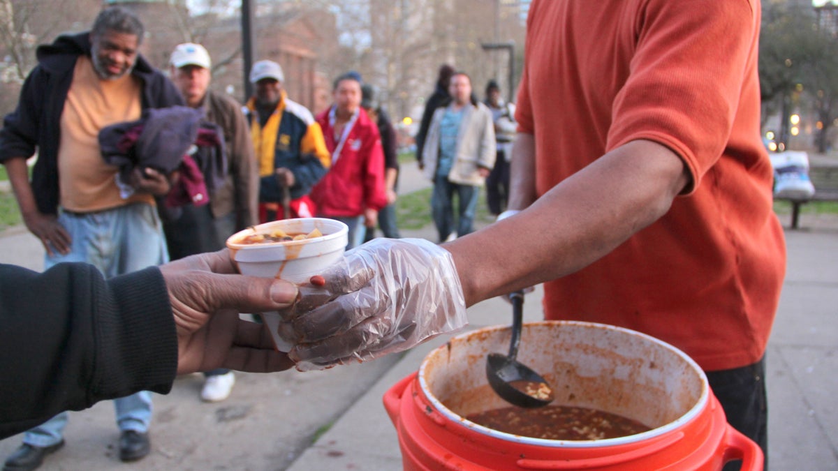 Homeless and hungry people line up for a meal near Logan Circle across from the Family Court building on Vine Street. (Emma Lee/WHYY file)