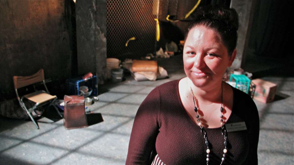 Rebecca May Flowers, artistic associate at Theatre Horizon in Norristown, stands on the set of In the Blood, a reinterpretation of The Scarlet Letter that focuses on homelessness. (Emma Lee/WHYY)